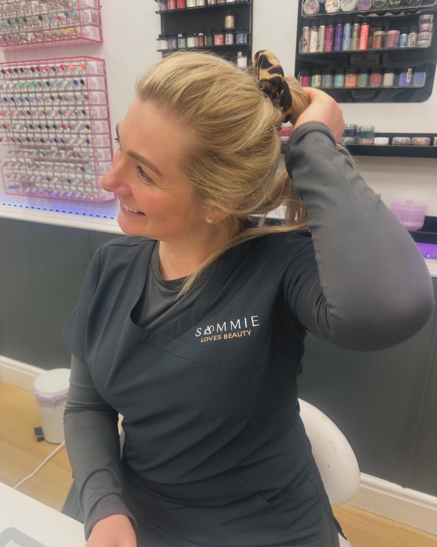 Sammie at the nail desk in her Sammie Loves Beauty tunic